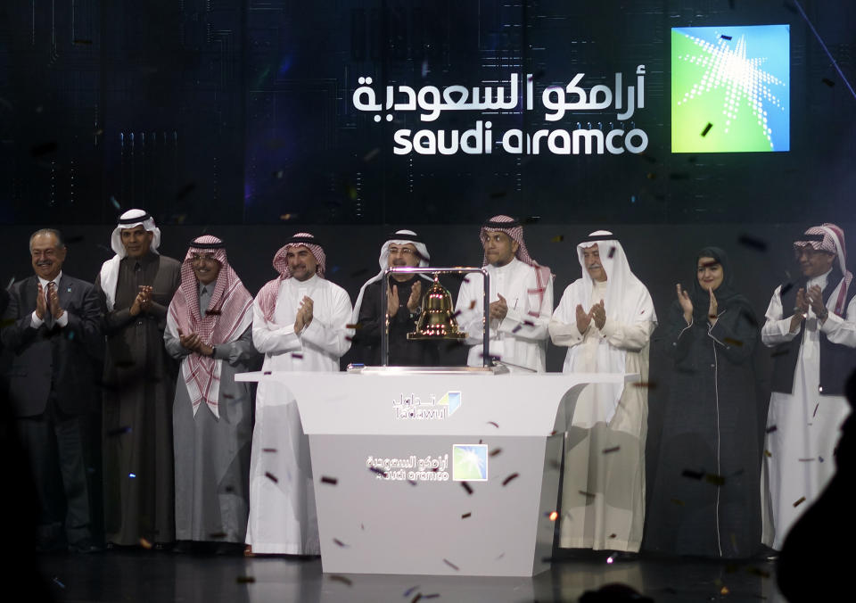 Saudi Arabia's state-owned oil company Saudi Armco and stock market officials celebrate during the official ceremony marking the debut of Aramco's initial public offering (IPO) on the Riyadh's stock market in Riyadh, Saudi Arabia, Wednesday, Dec. 11, 2019. (AP Photo/Amr Nabil)