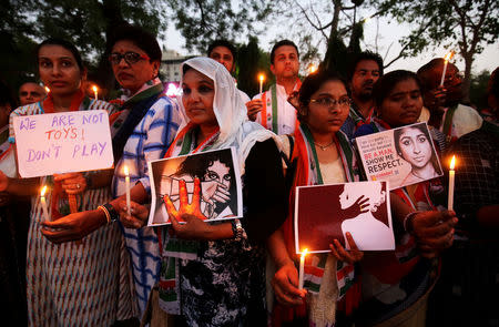 Supporters of India's main opposition Congress party participate in a candle light vigil as they protest against the rape of an eight-year-old girl in Kathua near Jammu, and a teenager in Unnao, Uttar Pradesh state, in Ahmedabad, India April 13, 2018. REUTERS/Amit Dave