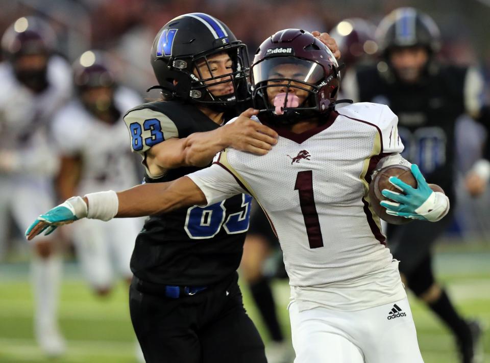 Blanchard's Brayson Carter avoids the tackle of Newcastle's Toby Batchelder on his way to a kickoff return for a touchdown on Friday in Newcastle.