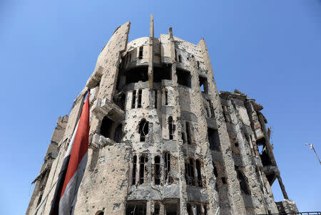 A damaged high-rise building is seen near the Old City of Mosul, Iraq August 5, 2017. Islamic State executed numerous people in the past three years by pushing them from the top of the building. REUTERS/Marius Bosch