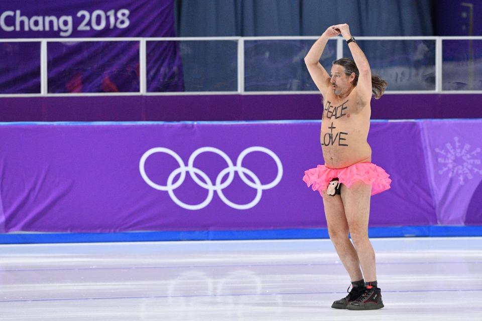 <p>A shirtless man clad in a tutu dances on the rink following the men’s 1,000m speed skating event medal ceremony during the Pyeongchang 2018 Winter Olympic Games at the Gangneung Oval in Gangneung on February 23, 2018. / AFP PHOTO / Mladen ANTONOV </p>