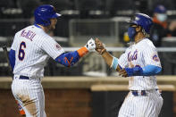 New York Mets' Jeff McNeil, left, fist bumps Francisco Lindor after Lindor scored on a sacrifice fly ball by Pete Alonso during the seventh inning of a baseball game Wednesday, April 14, 2021, in New York. (AP Photo/Frank Franklin II)