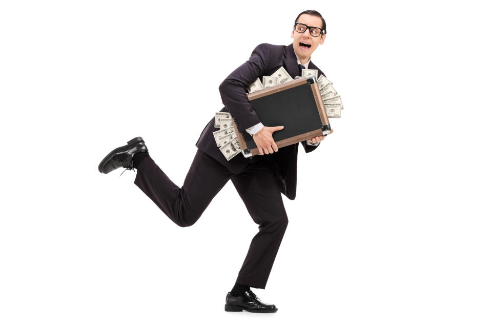Guy in a suit running with a briefcase full of money.