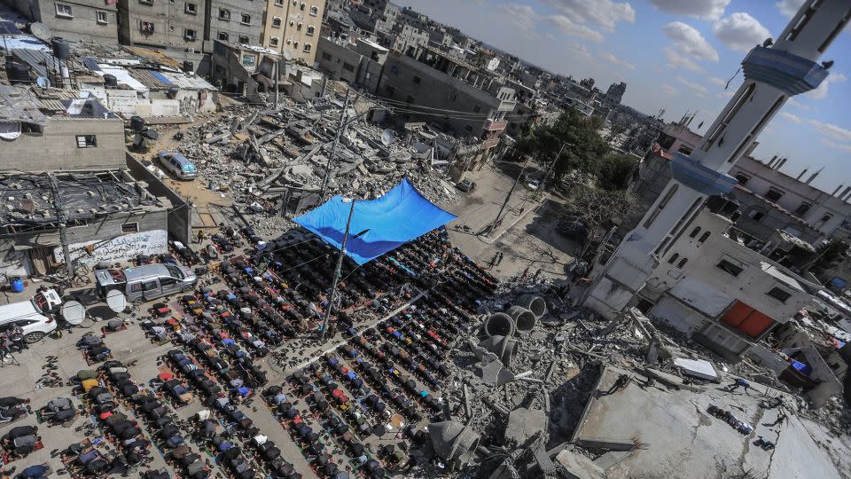 Palestinians perform Friday prayers at the Al-Farouq Mosque, which was destroyed by Israeli bombardment, in Rafah, in southern Gaza, on March 8. - Mohammed Talatene/picture alliance/Getty Images