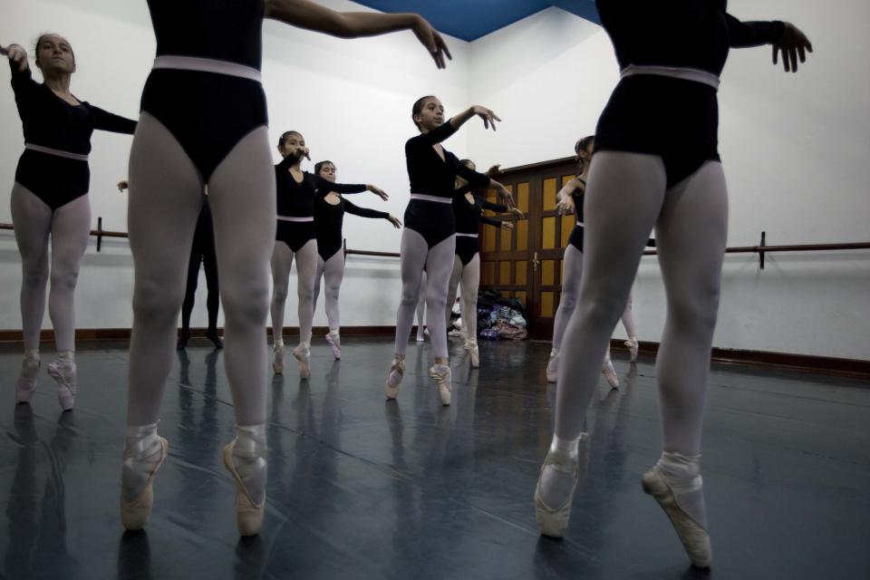 In this Aug. 28, 2012 photo, a ballet dancers practice for a competition between ballet schools at the National Superior Ballet School in Lima, Peru. Nearly 100 girls and boys from Colombia, Venezuela, Chile, France and Peru are submitting themselves to a week-long competition hoping to win medals from Peru's national ballet school _ and perhaps a grant to study in Miami. (AP Photo/Martin Mejia)