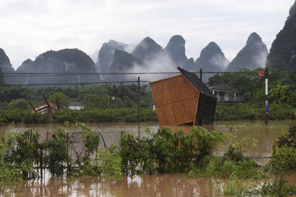 In this June 7, 2020, photo released by Xinhua News Agency, facilities at a tourism site are toppled in the aftermath of a flood after heavy downpour in Yangshuo of Guilin, south China's Guangxi Zhuang Autonomous Region. Flooding in south and central China has lead to more than a dozen deaths and forced hundreds of thousands of people from their homes, the government said Wednesday. (Lu Boan/Xinhua via AP)