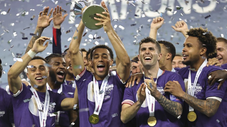 Tyler Adams, scorer of the first goal, lifts the trophy for the US. - Omar Vega/Getty Images