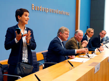 Frauke Petry, chairwoman of the anti-immigration party Alternative fuer Deutschland (AfD) leaves a news conference next to Joerg Meuthen (2nd L), leader of the party and top candidates Alice Weidel (2nd R) and Alexander Gauland in Berlin, Germany, September 25, 2017. REUTERS/Fabrizio Bensch TPX IMAGES OF THE DAY