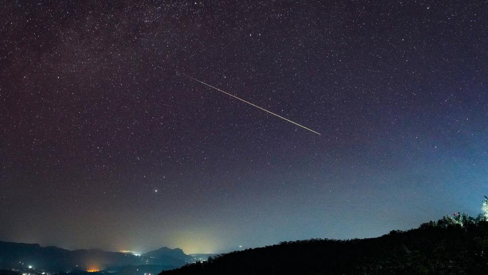     A streak of light crosses the night sky. 