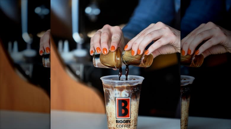 barista pouring shots into Biggby Coffee cup