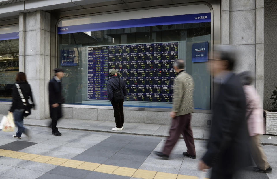 A man looks at an electronic stock price indicator in Tokyo Monday, April 7, 2014. Internet and technology stocks tumbled across Asia on Monday as a sell-off spread from Wall Street where investors knocked down such companies over worries about excessively high valuations. Japan's Nikkei 225 led regional declines, dropping 254.92 points, or 1.69 percent to closed at 14,808.85. (AP Photo/Shizuo Kambayashi)