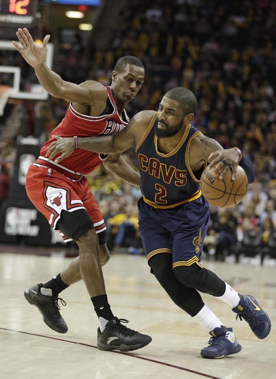 Cleveland Cavaliers' Kyrie Irving (2) drives past Chicago Bulls' Rajon Rondo (9) during the second half of an NBA basketball game, Saturday, Feb. 25, 2017, in Cleveland. The Bulls won 117-99. (AP Photo/Tony Dejak)