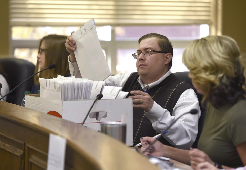 Richard House, Chief Deputy of Daviess County Clerk's Office, pulls out a voting machine printout during the re-canvass of the Daviess County votes in the 2019 General Election for Governor on Thursday, Nov. 14, 2019 at the Daviess County Courthouse in Owensboro, Ky. Republican Gov. Matt Bevin conceded to Democratic archnemesis Andy Beshear on Thursday, putting an end to Kentucky’s bitterly fought governor’s race and setting the stage for divided government. (Alan Warren/The Messenger-Inquirer via AP)