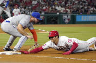 Los Angeles Angels' Shohei Ohtani, right, dives back to first as New York Mets designated hitter Pete Alonso puts a late tag on him during the fifth inning of a baseball game Friday, June 10, 2022, in Anaheim, Calif. (AP Photo/Mark J. Terrill)