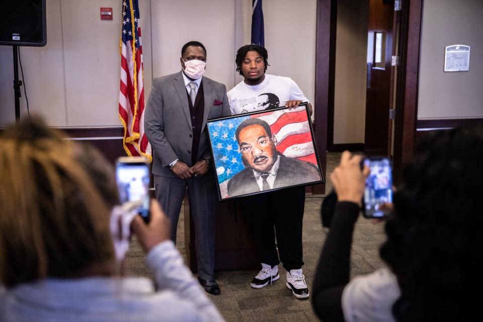 Joey Withinarts poses for a photo with a drawing he made of Dr. Martin Luther King Jr. with Pastor Gerald Williams, the keynote speaker at the city of Greer’s annual MLK celebration at city hall, Monday, January 18, 2021.