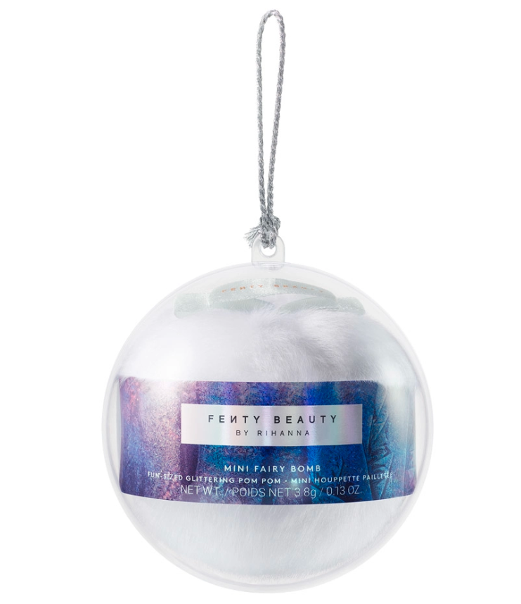 Pictured is a silver and blue Fenty Beauty Mini Fairy Bomb Glittering Pom Pom