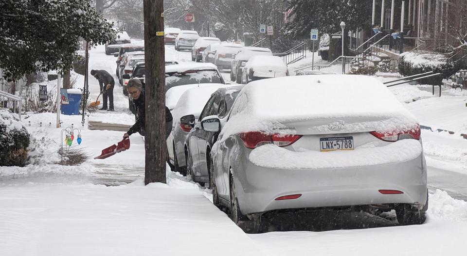 People shovel snow in Manchester Township.