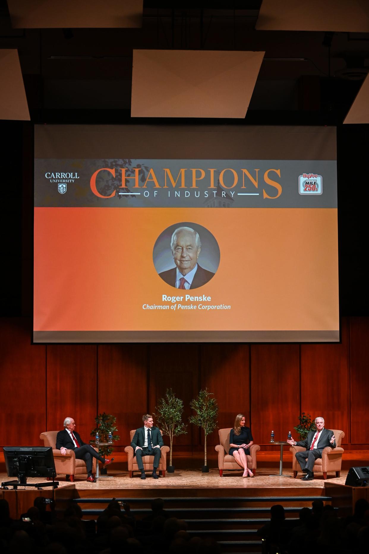 Tim Sullivan, right, dean of Carroll University's Sullivan School of Business and Technology, moderates a panel discussion with, from left, Penske Corporation chairman Roger Penske, reigning Indianapolis 500 winner Josef Newgarden and Wisconsin State Fair CEO Shari Black on Tuesday in Waukesha.