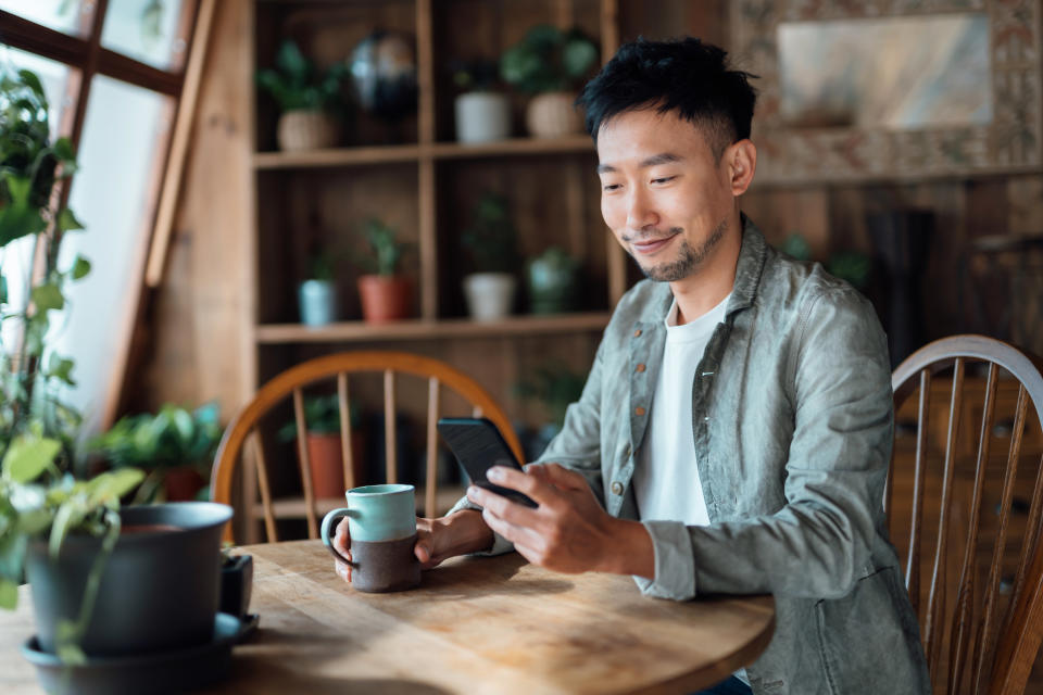 young man drinking coffee at home