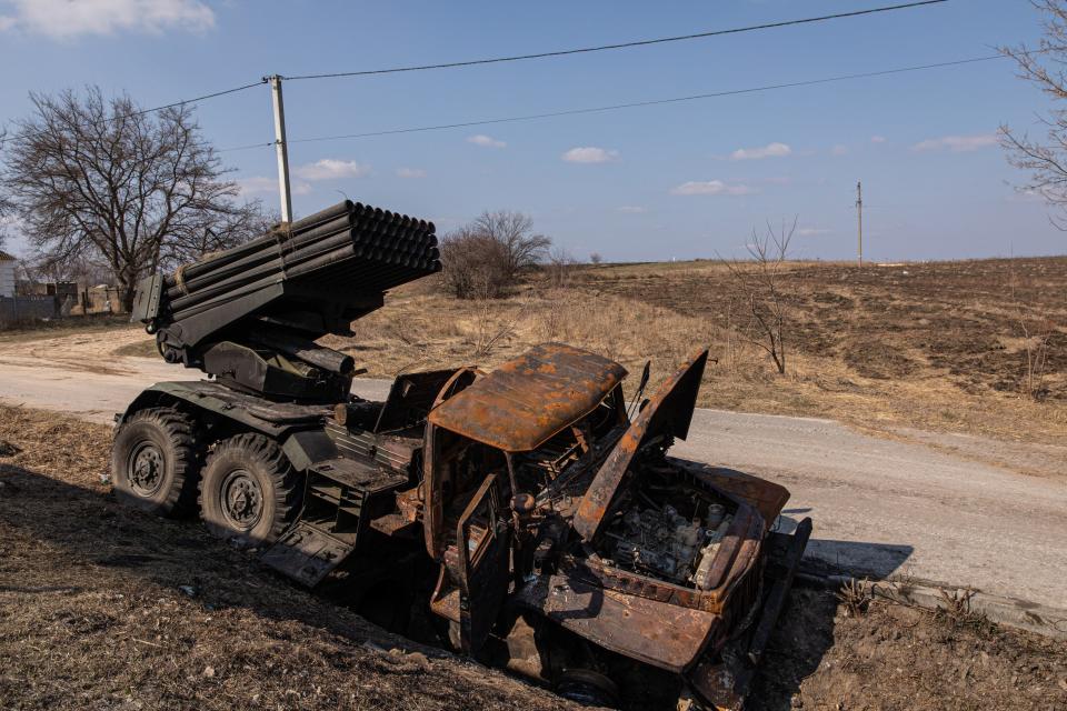 A destroyed Russian multiple rocket system vehicle is left in a ditch in Kyiv Oblast.