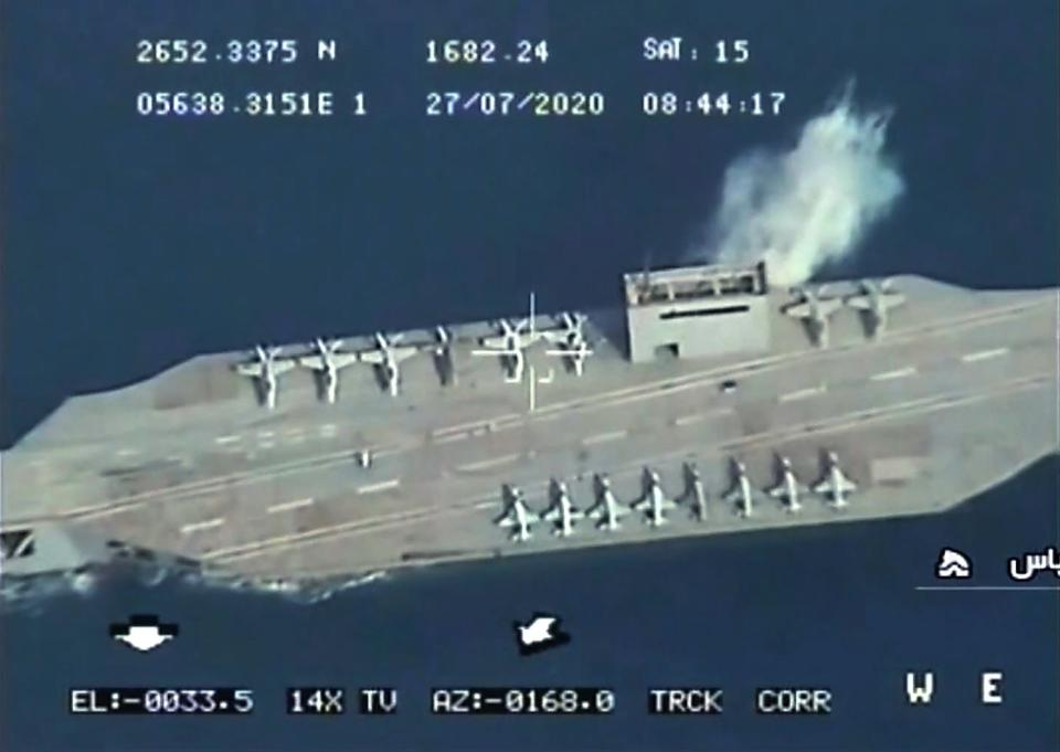 An Iranian mockup imitating a US aircraft carrier being hit during a military exercise near the Strait of Hormuz: IRIB NEWS AGENCY/AFP via Getty I