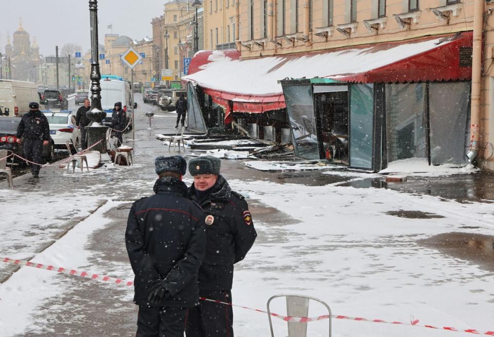 <div class="inline-image__caption"><p>Police officers stand guard at the scene of the cafe explosion in which Russian military blogger Vladlen Tatarsky, (real name Maxim Fomin) was killed the day before in Saint Petersburg, Russia. </p></div> <div class="inline-image__credit">Anton Vaganov/Reuters</div>