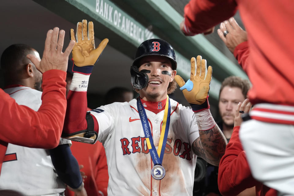 Boston Red Sox's Jarren Duran, center, is congratulated in the dugout for his home run against the Tampa Bay Rays during the sixth inning of a baseball game Thursday, May 16, 2024, in Boston. (AP Photo/Steven Senne)