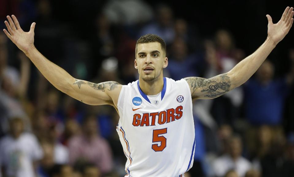 Florida guard Scottie Wilbekin (5) celebrates his basket against Dayton's Vee Sanford during the first half in a regional final game at the NCAA college basketball tournament, Saturday, March 29, 2014, in Memphis, Tenn. (AP Photo/John Bazemore)