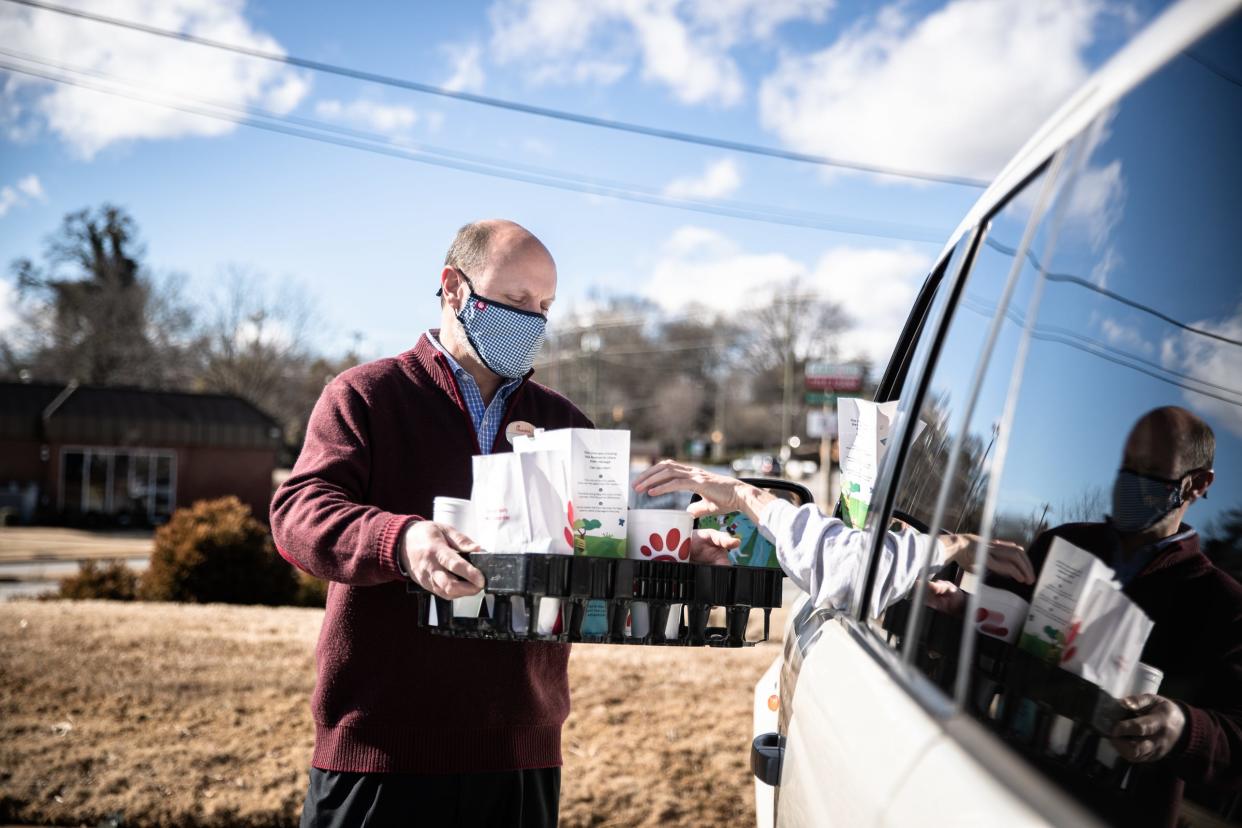 Steven Bryant, the owner of the Chick-fil-A at Greenville’s Cherrydale, brings an order to a customer, Monday, Feb 22, 2021.