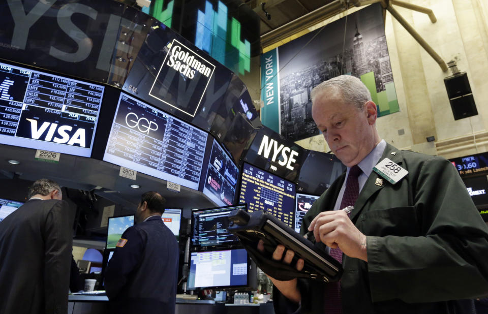 Trader James Riley works on the floor of the New York Stock Exchange Wednesday, Feb. 5, 2014. The U.S. stock market is edging lower in early trading after a modest recovery the day before. (AP Photo/Richard Drew)