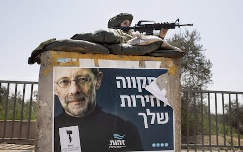 An Israeli soldier guards a security position in the Israeli settlement of Ariel, West Bank (file photo) - Credit: Kobi Wolf/Bloomberg