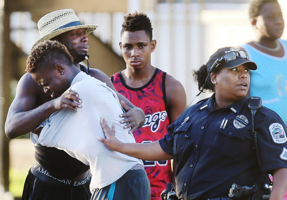 <p>People embrace after a fatal shooting at Club Blu in Fort Myers, Fla., Monday, July 25, 2016. (Kinfay Moroti/The News-Press via AP)</p>