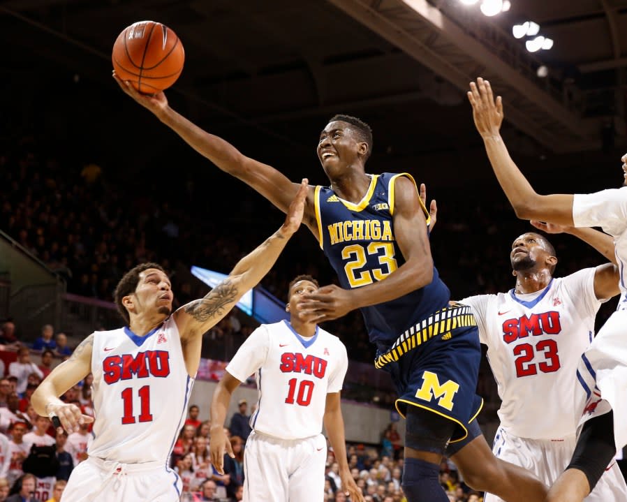 FILE – In this Dec. 8, 2015, file photo, Michigan guard Caris LeVert (23) shoots the ball in front of SMU guard Nic Moore (11) and guard Jarrey Foster (10) during the first half of an NCAA basketball gamein Dallas. Now that he’s been able to return to the court, the question is how soon LeVert will get back in game shape for Michigan. By (AP Photo/Jim Cowsert, File)