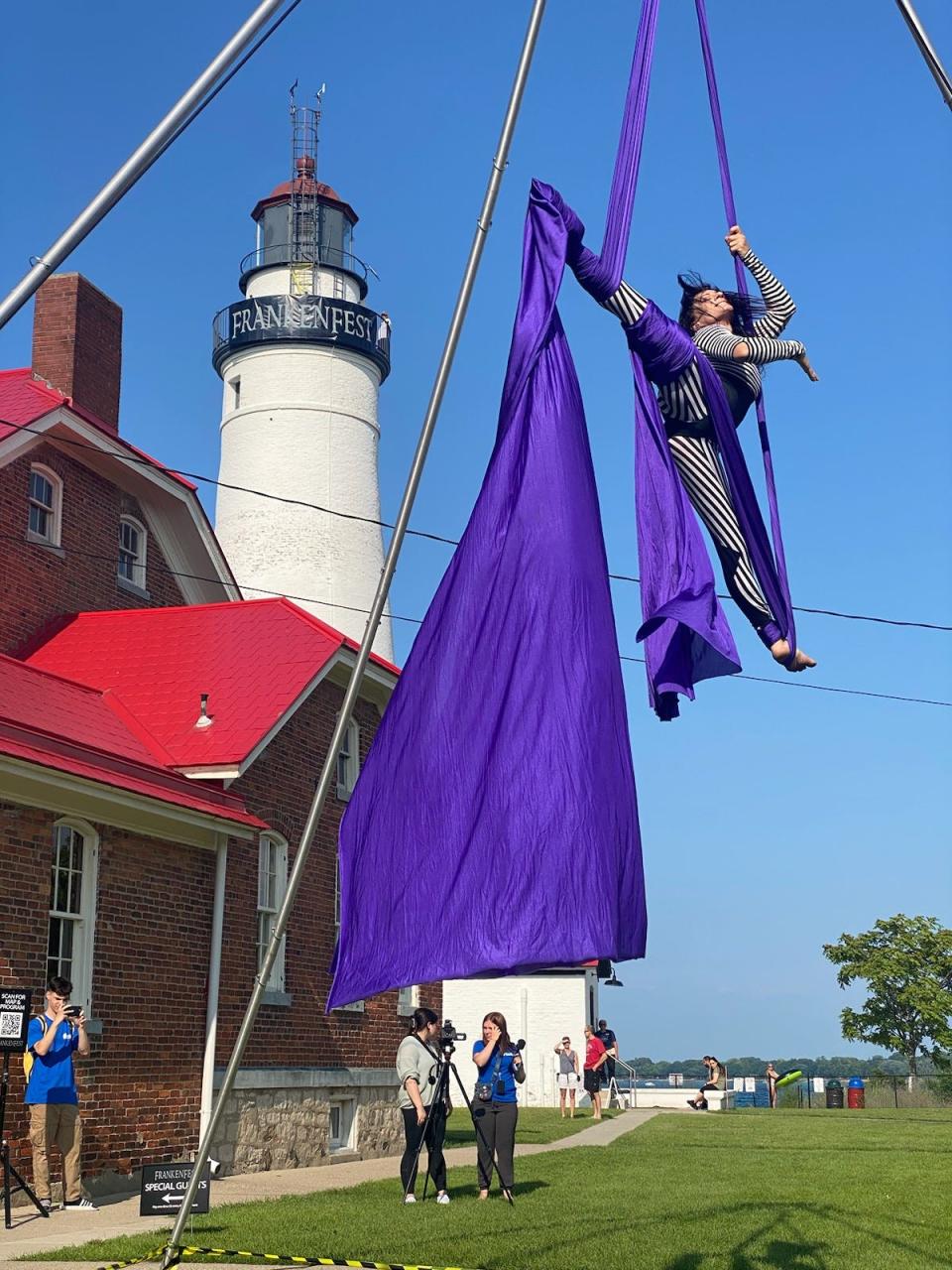 A dancer with D3 circus performs at Frankenfest in front of the Fort Gratiot Lighthouse