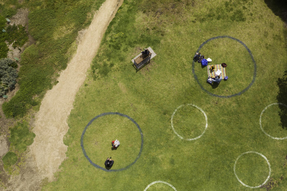 people hanging outside with social distance circles in the ground