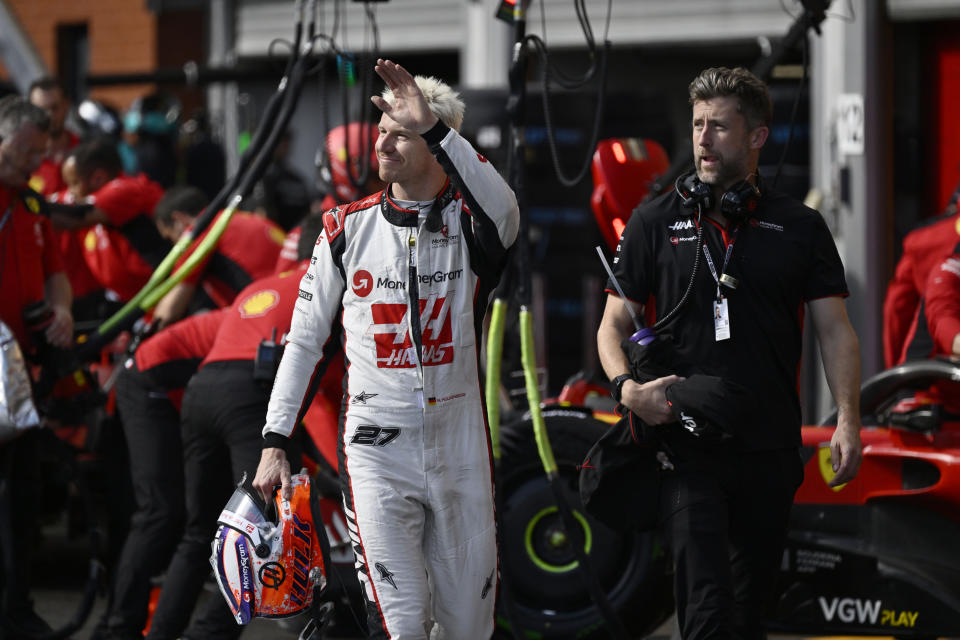 Haas driver Nico Hulkenberg of Germany waves as he walks near his team garage during the qualifying session ahead of the Formula One Grand Prix at the Spa-Francorchamps racetrack in Spa, Belgium, Friday, July 28, 2023. The Belgian Formula One Grand Prix will take place on Sunday. (John Thys, Pool Photo via AP)