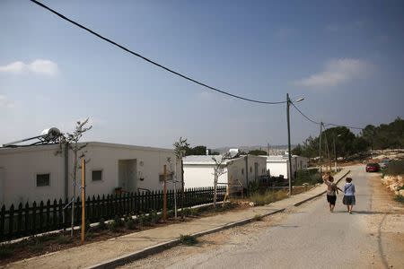 Israeli women walk in a Jewish settlement known as "Gevaot", in the Etzion settlement bloc, near Bethlehem August 31, 2014. REUTERS/Ronen Zvulun