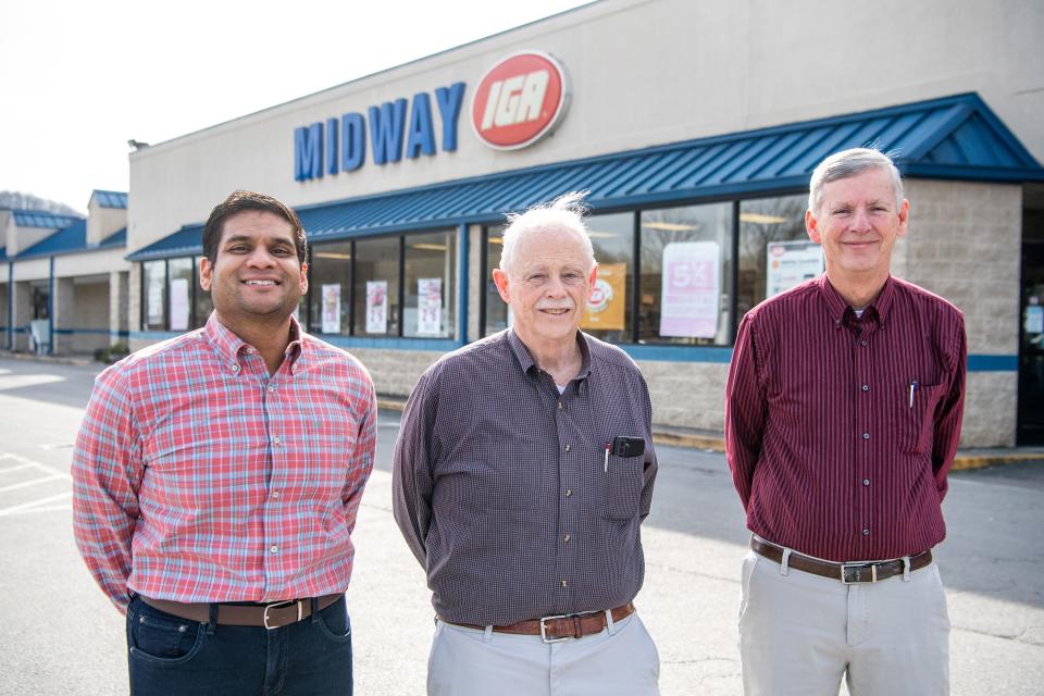 New owner Haven Gopal, left, is photographed with former owners Joe Longmire, center, and Dale Longmire, right, outside of the Midway IGA grocery store in Corryton.