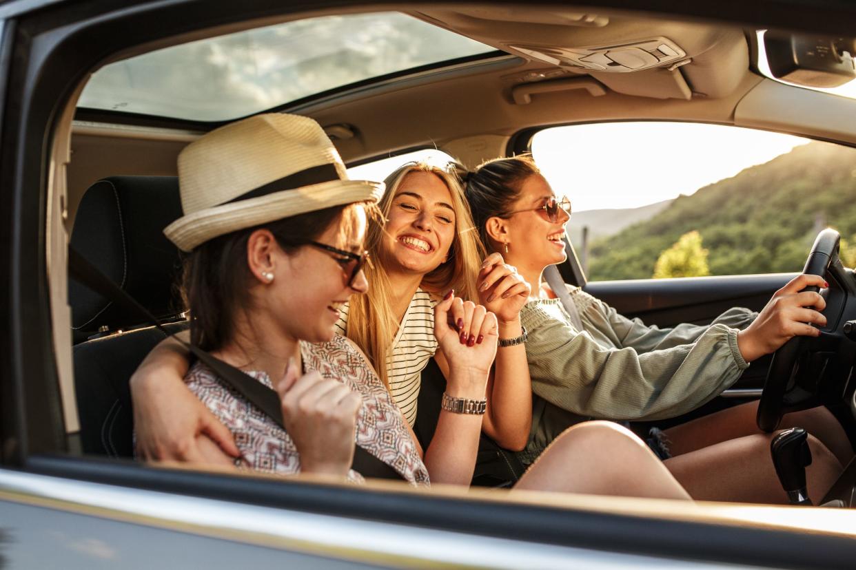 Three best female friends travel together.They drives a car and making fun.Summer adventure..