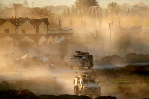 US troops supporting the Syrian Democratic Forces patrol the Euphrates valley town of Hajin, on December 15, 2018 following its capture from the Islamic State group in a deployment thrown into doubt by US pullout plans