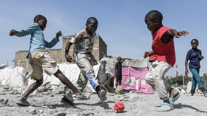 Children playing football in Nairobi, Kenya - Thursday 10 March 2022