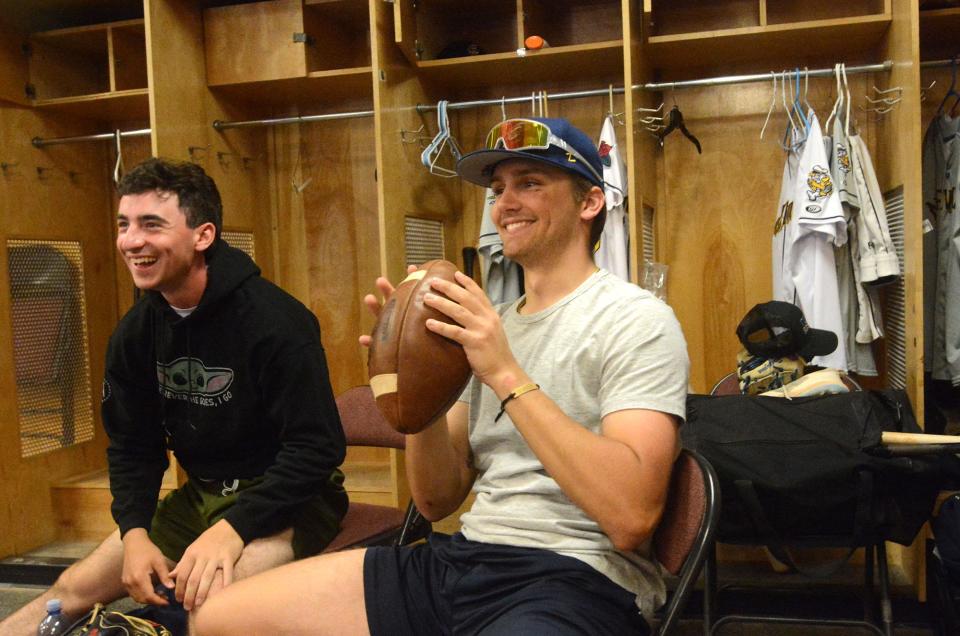 Sea Unicorn players Jackson Ferrigno of Farmington, attending UConn, left, and Zac Zyons of South Kingston, R. I., attending Bryant University, throw a football with teammates in the locker room after baseball practice Wednesday at Dodd Stadium in Norwich.