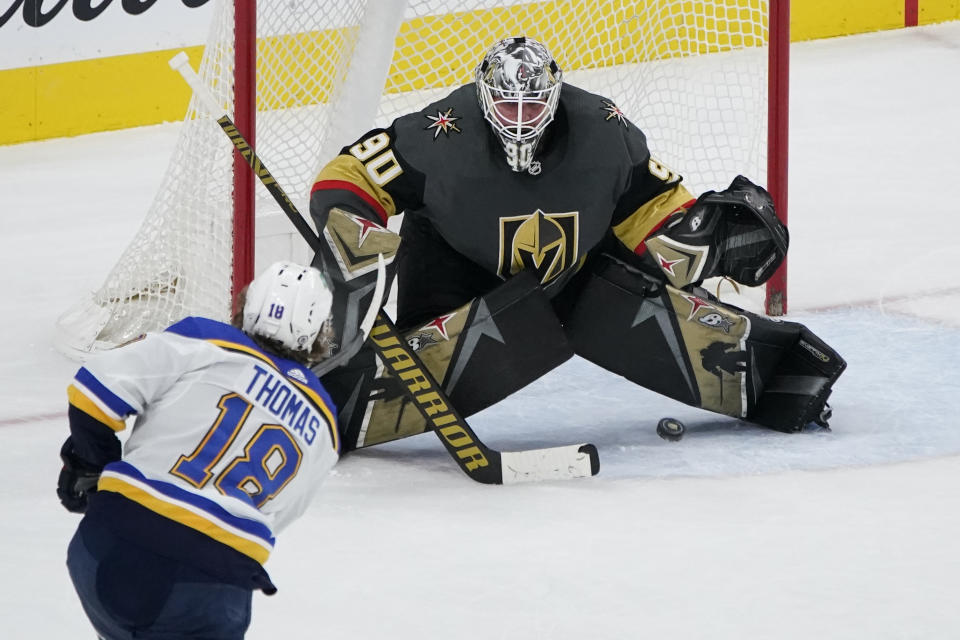 Vegas Golden Knights goaltender Robin Lehner (90) blocks a shot by St. Louis Blues center Robert Thomas (18) during overtime of an NHL hockey game Friday, May 7, 2021, in Las Vegas. (AP Photo/John Locher)