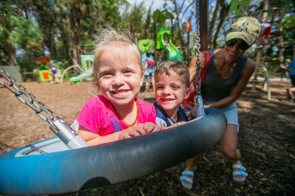 Naples residents Amelia McLane, 2, and her cousin, Ryan Curry, 4, smile for a portrait while being pushed on a swing by McLane's aunt, Julie Curry, at the Naples Zoo on Friday, October 14, 2022, in Naples. FL. 

Just 17 days after Hurricane Ian swept through Collier County, the Naples Zoo once again opened its doors to the public. Although a few feet of storm surge flooded the zoo, most animals were safely housed in hurricane resistant structures. After some cleanup to the facilities, the zoo was able to once again welcome animal lovers on to the premises.