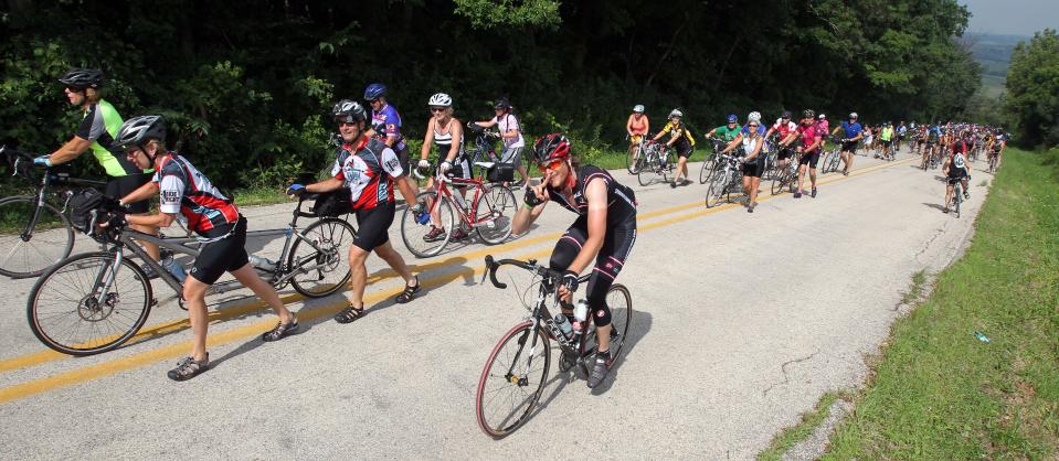 Some RAGBRAI riders rode, some walked their bikes up Potter Hill outside of Graf on July 31, 2010. Many riders said the mile long, steep hill was the hardest hill they've ever had to climb. Many got off their bikes and walked much of the hill.