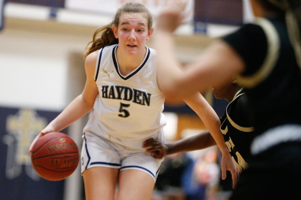 Hayden senior Lauren Sandstrom (5) looks for a pass against Topeka High in the second half of the senior night game Friday, Feb. 16, 2024.