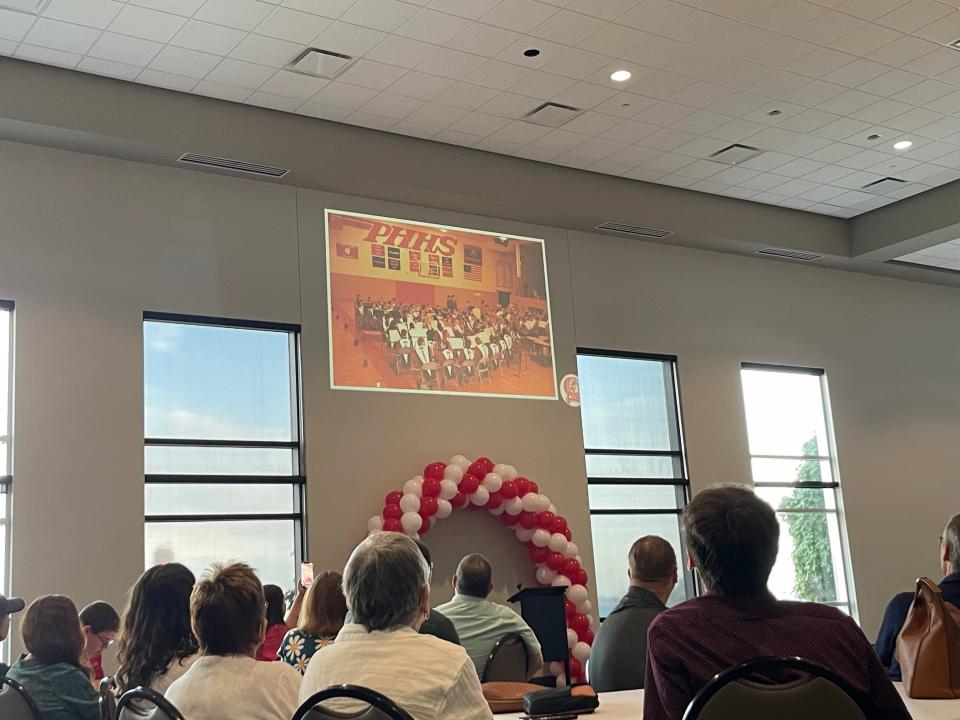 Port Huron High School Band Alumni and the Clark family watching a slide show dedicated to the late Robert Clark on July 28, 2023