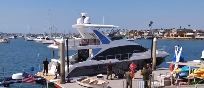 A man was accused of stealing this yacht in Newport Beach and crashing it into several others before being taken into custody on March 10, 2022. (NBC Los Angeles)