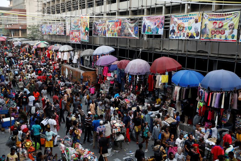 People crowd a market place as they shop in preparation for Christmas in Lagos