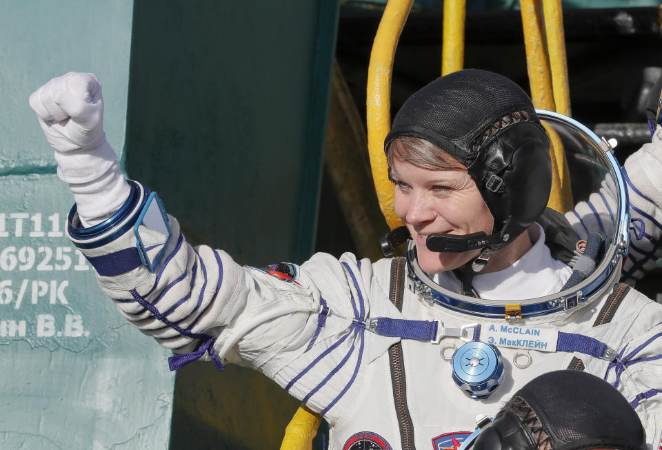 NASA astronaut Anne McClain, a member of the International Space Station expedition 58/59, gestures as she boards the Soyuz MS-11 spacecraft shortly before the launch in December 2018. She's accused of committing the first crime in space.